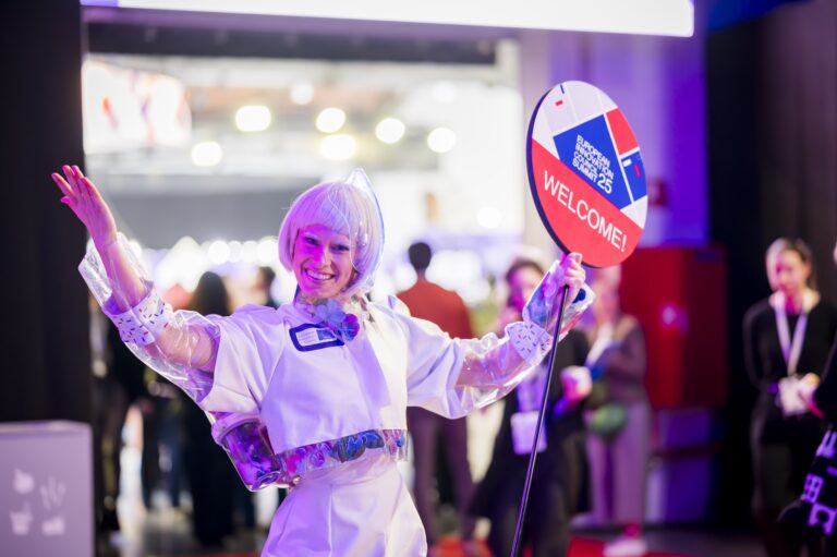 EIC Summit 2025: a woman in futuristic dress welcomes visitors