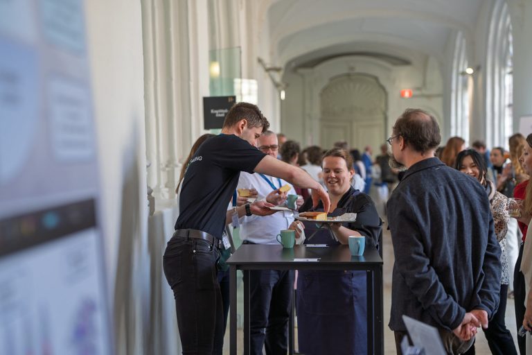 Euro-BioImaging team member at a booth.