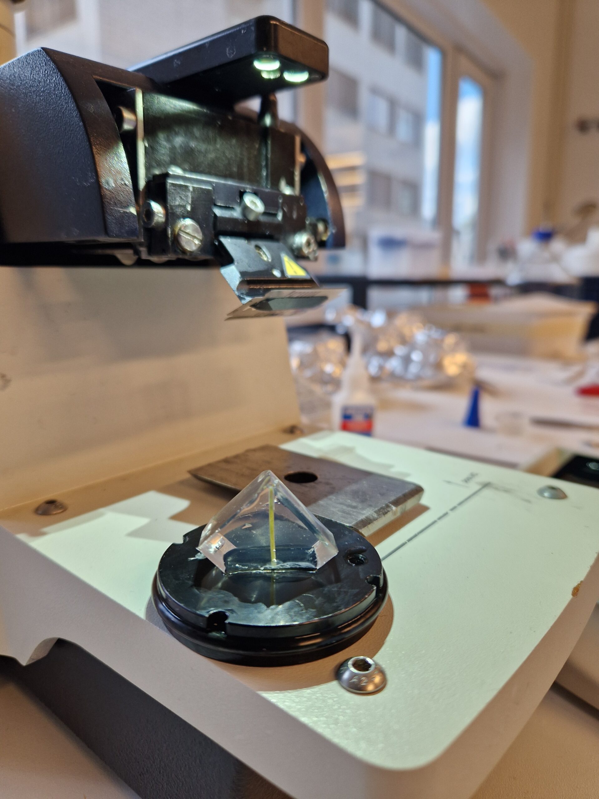 Photo of an embedding machine with a fixated wheat plant in resin.