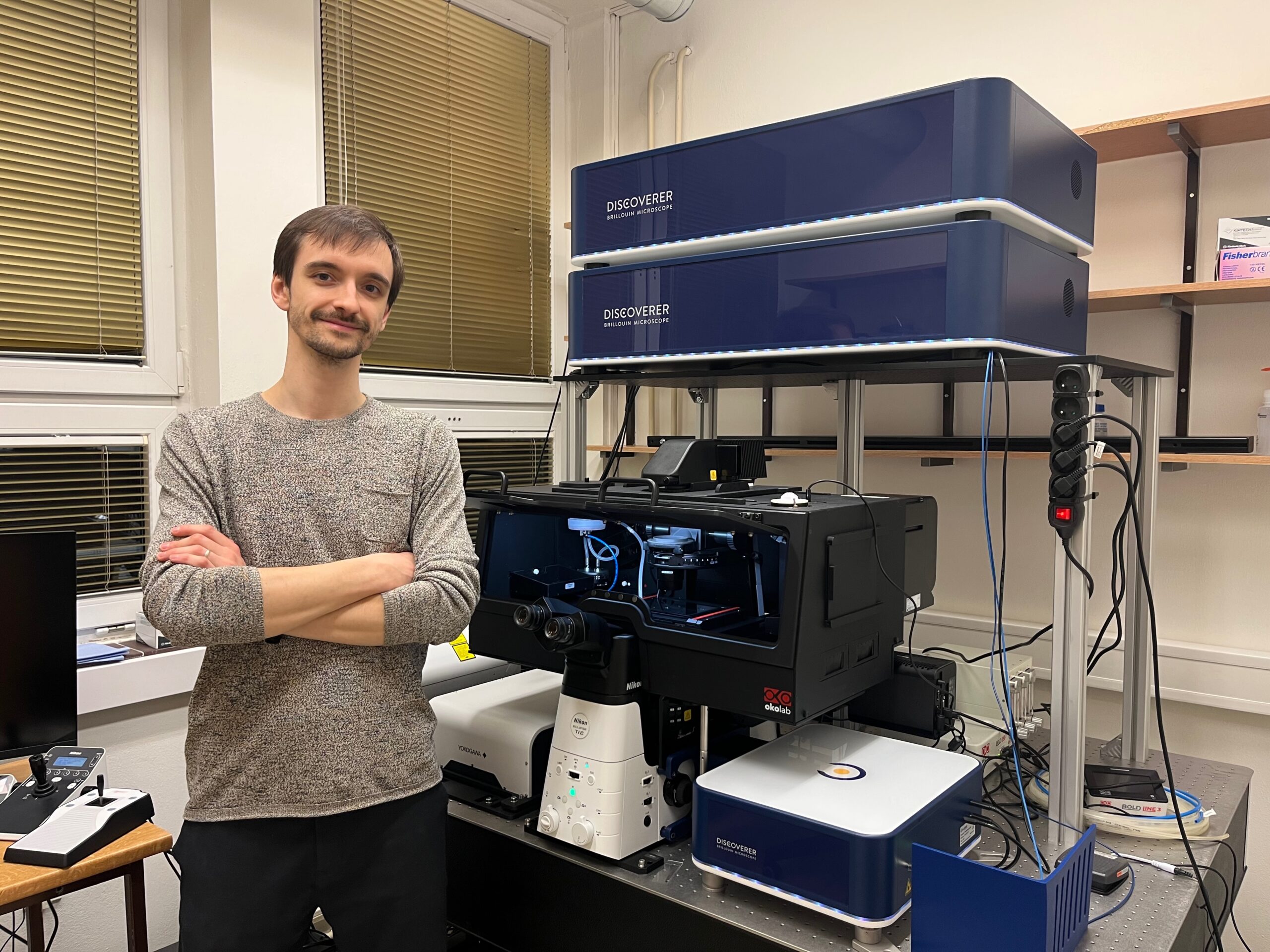 Man in front of a Brillouin Microscope.