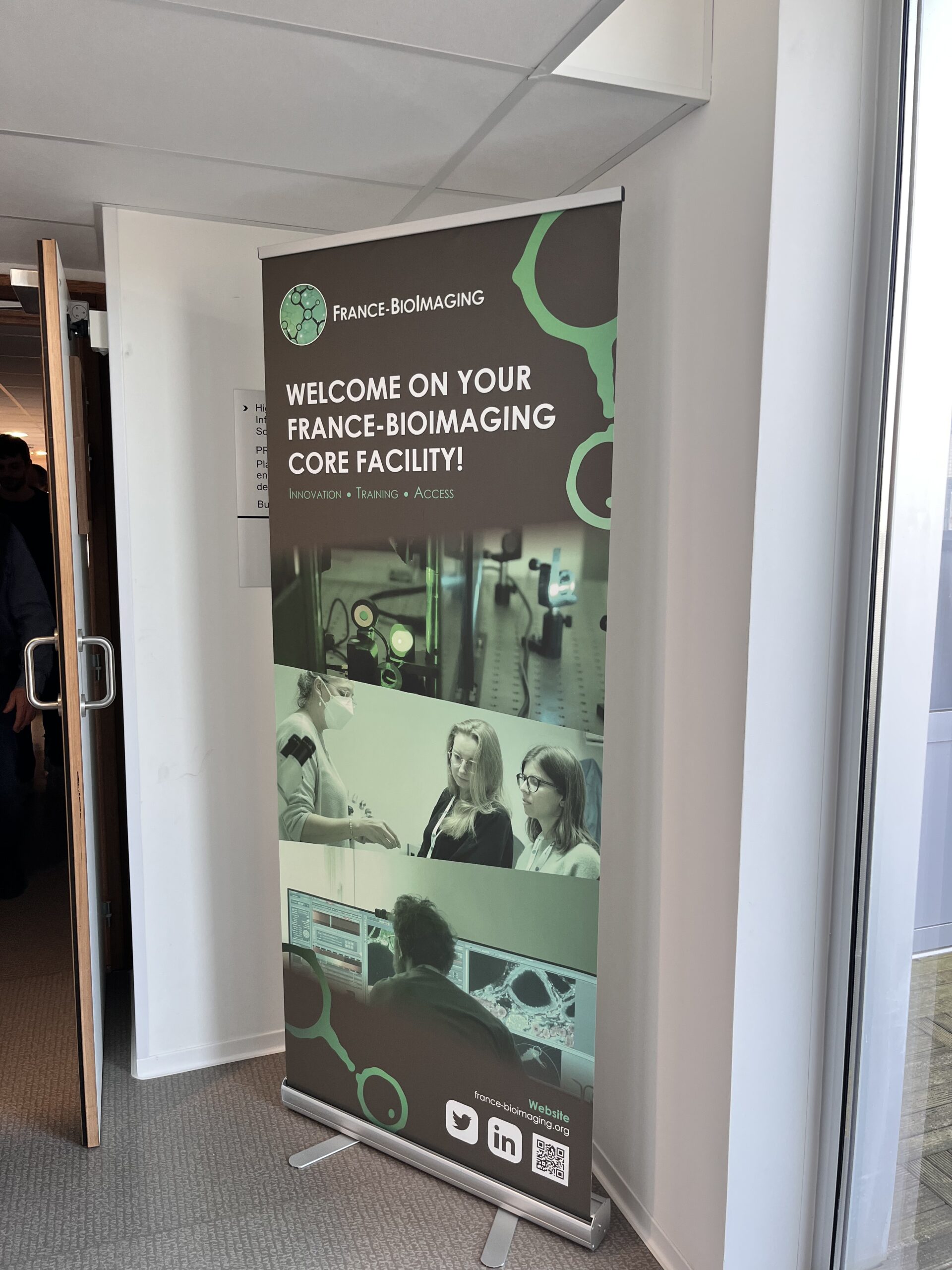 A poster of France BioImaging at the entrance of a lecture hall.
