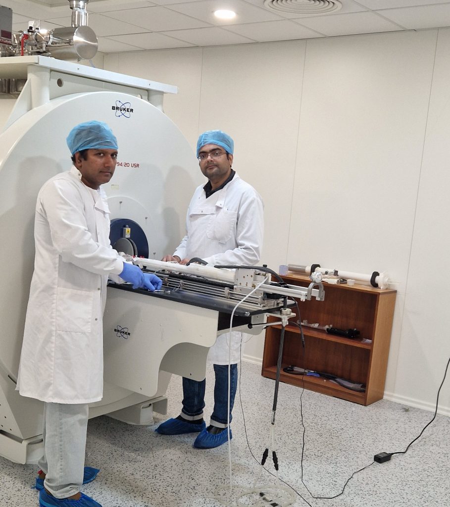Two men in front of the MRI.