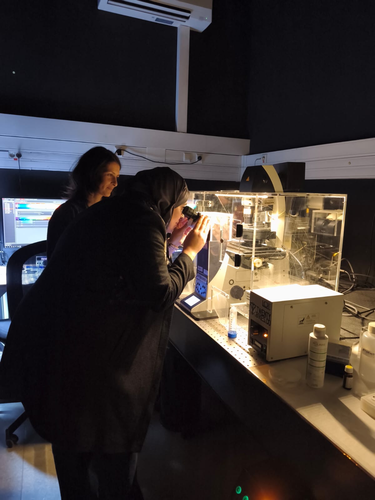 Samira Benadda, Waime Aissoug in front of the microscope as part of Imaging 4 All.