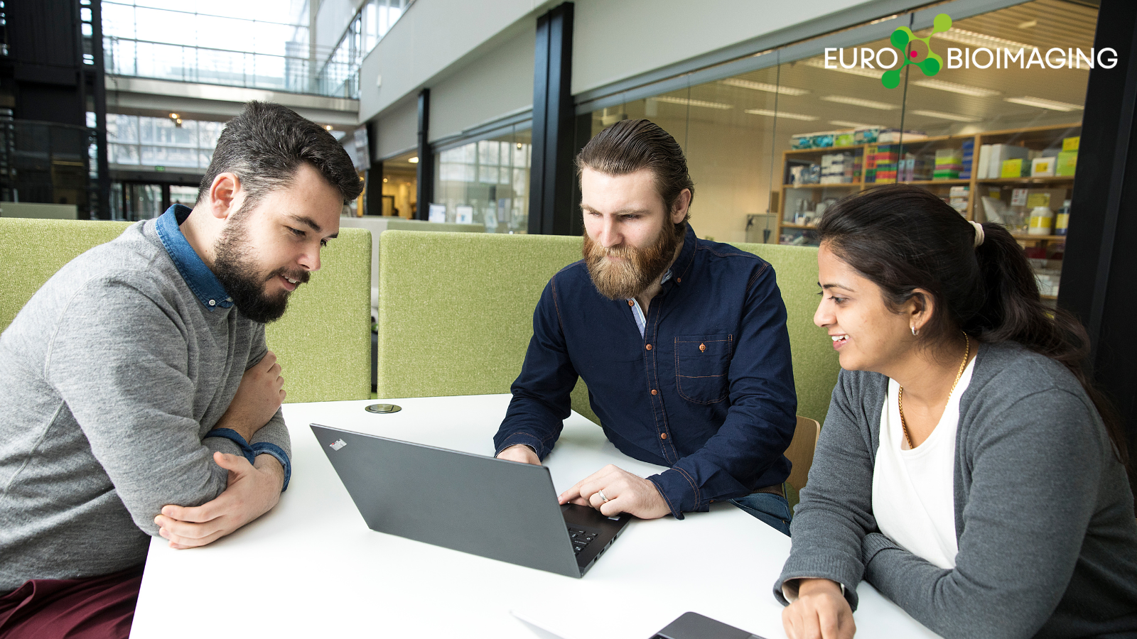 Three people in a meeting discussing an imaging project