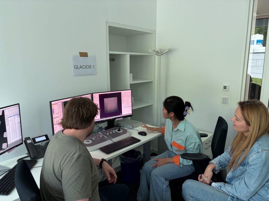 Researchers in front of a computer display.
