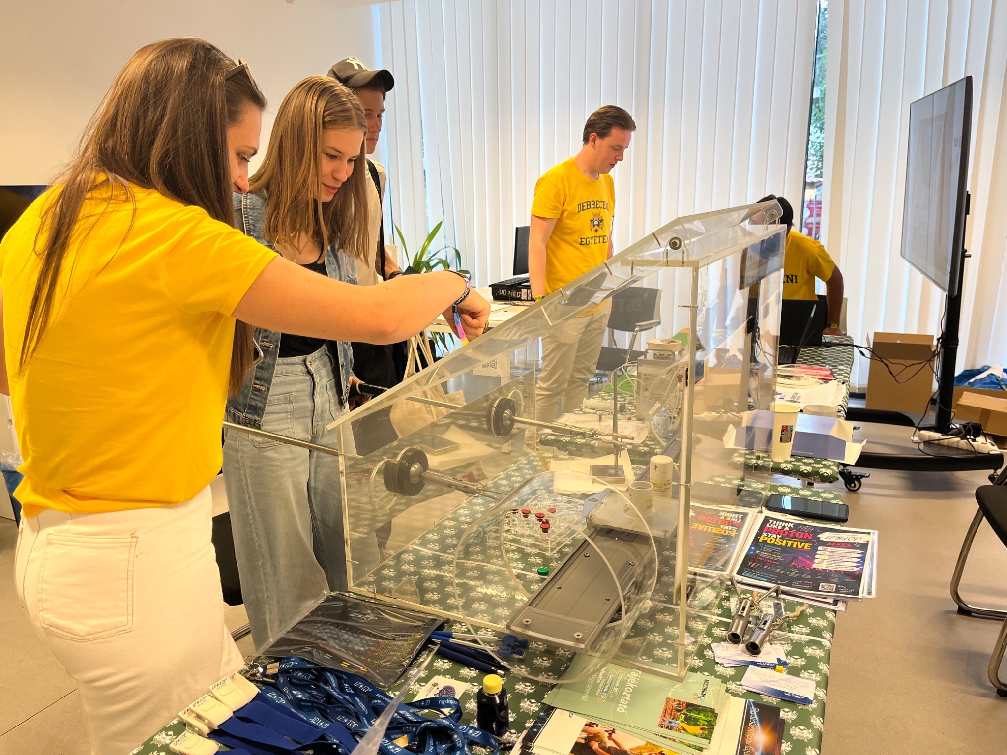 People playing a game that explains laboratory work and how a cyclotron produces isotopes.