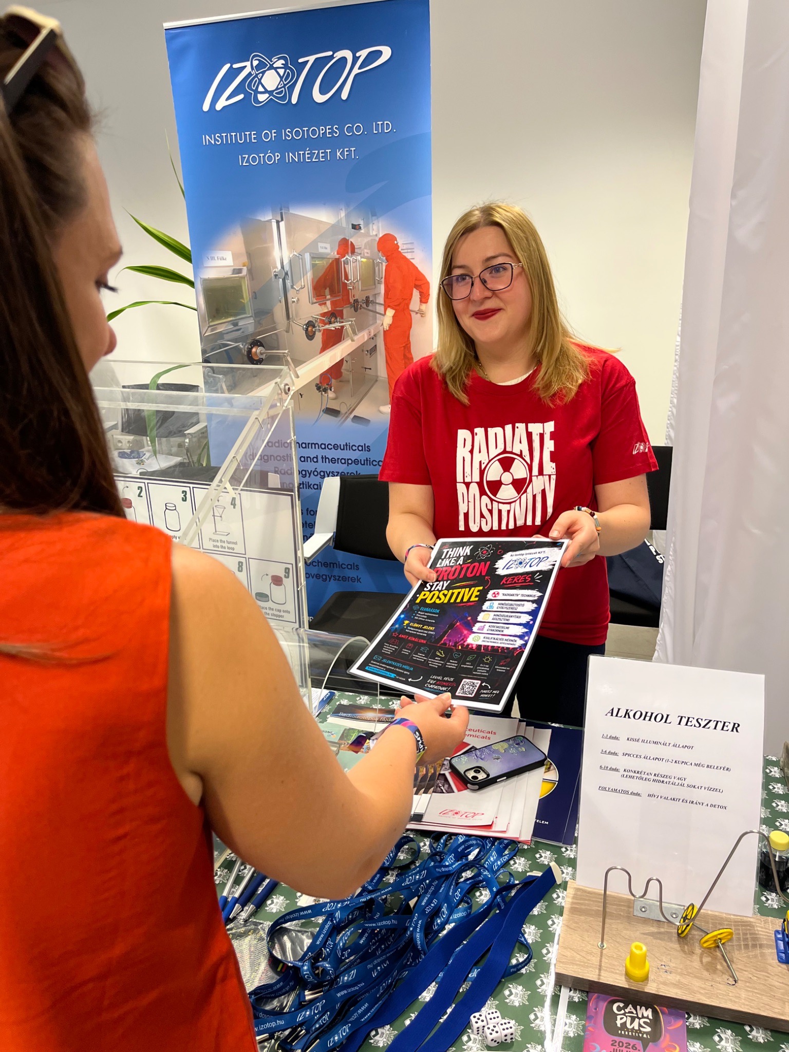 Scientists explaining their work at a fair with the general public.