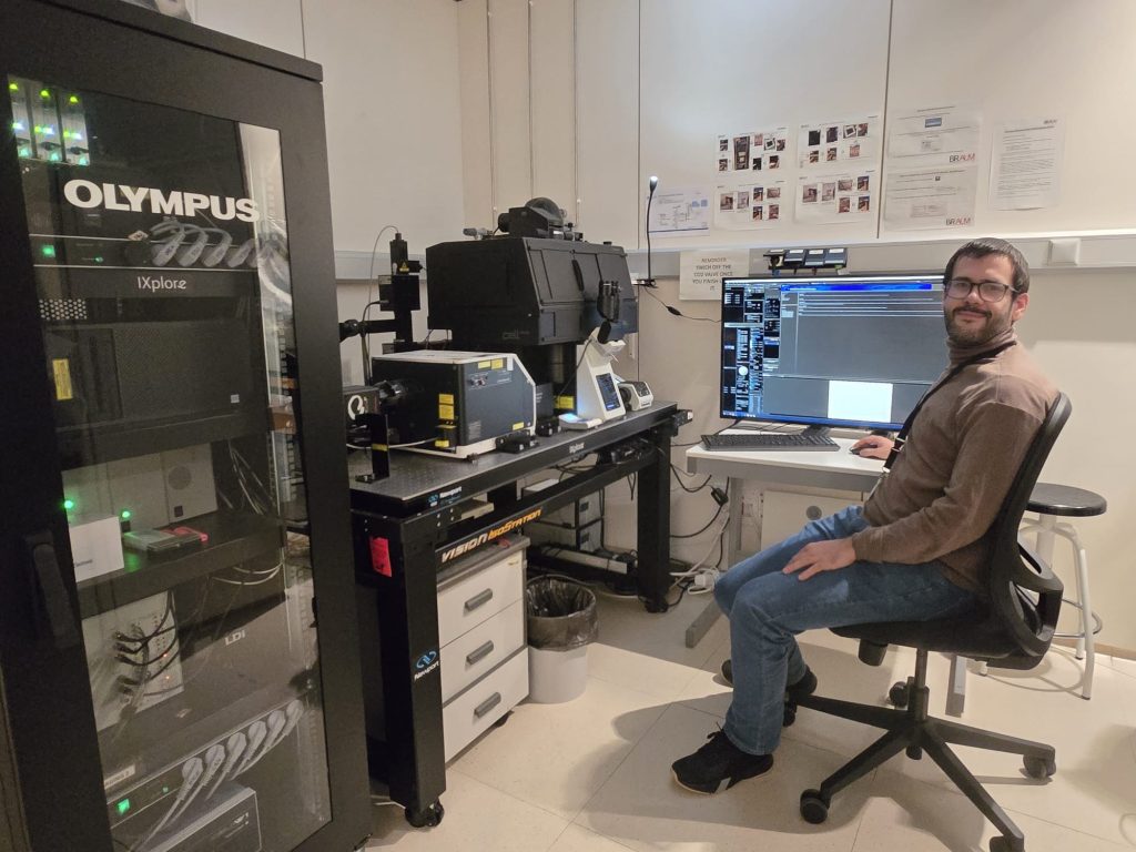 A man in front of a microscope