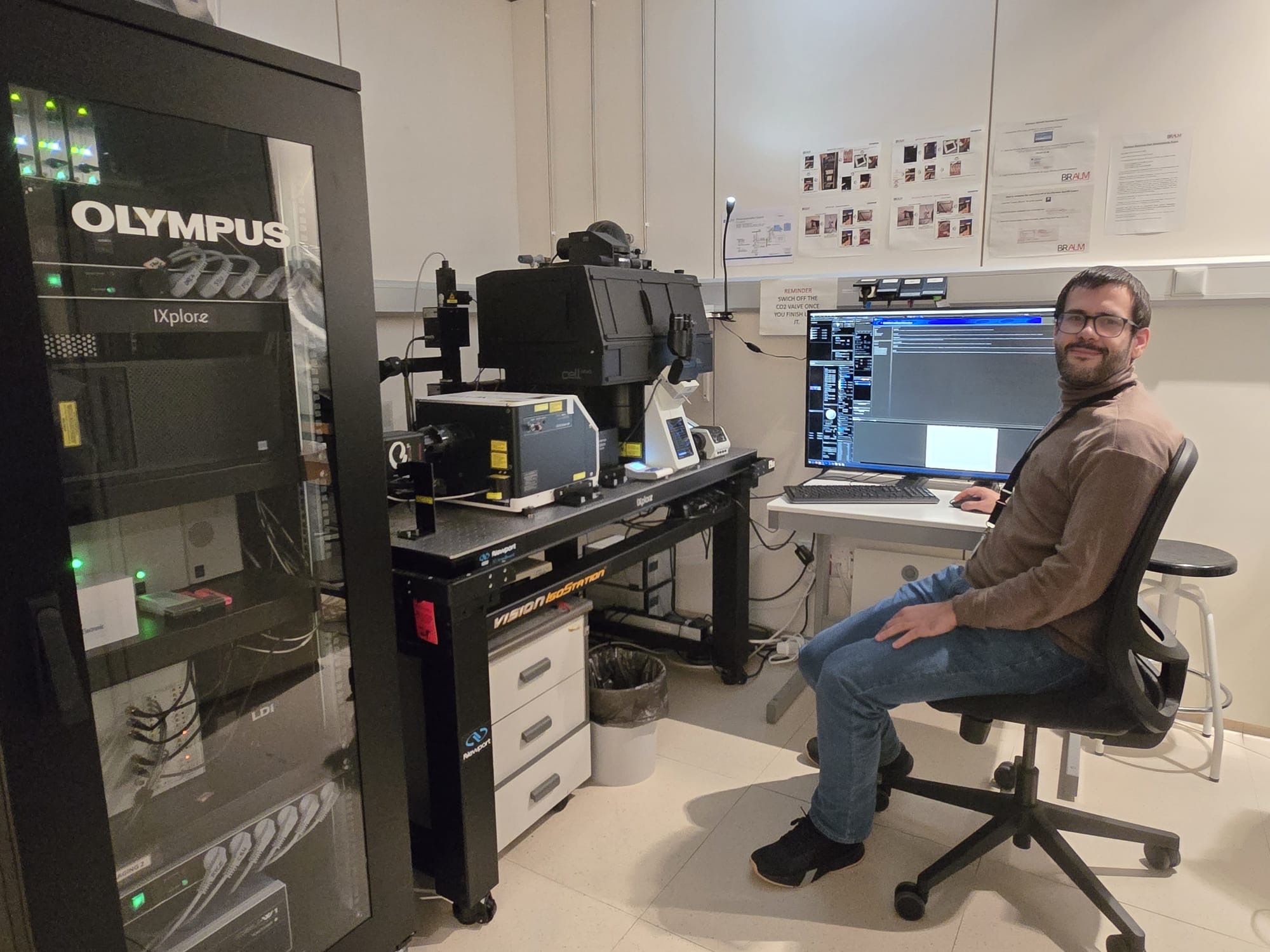 A man in front of a microscope
