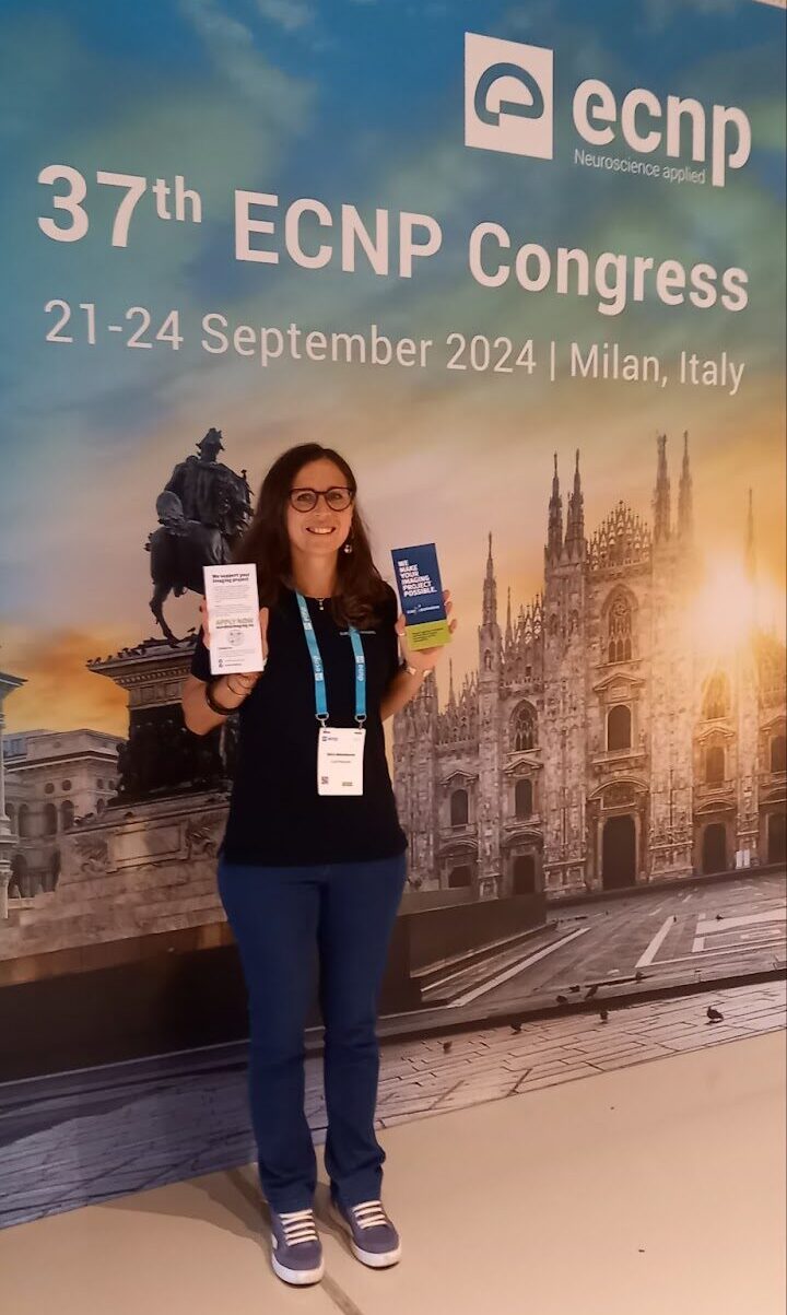 Alice Abbondanza at ECNP in Milan, with Euro-BioImaging brochures.